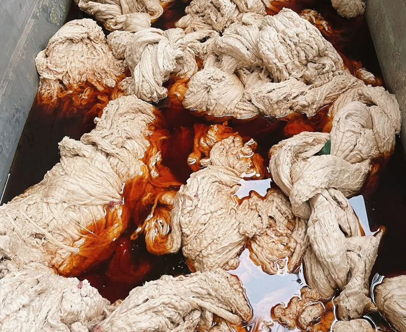 cotton thread being soaked in a trough